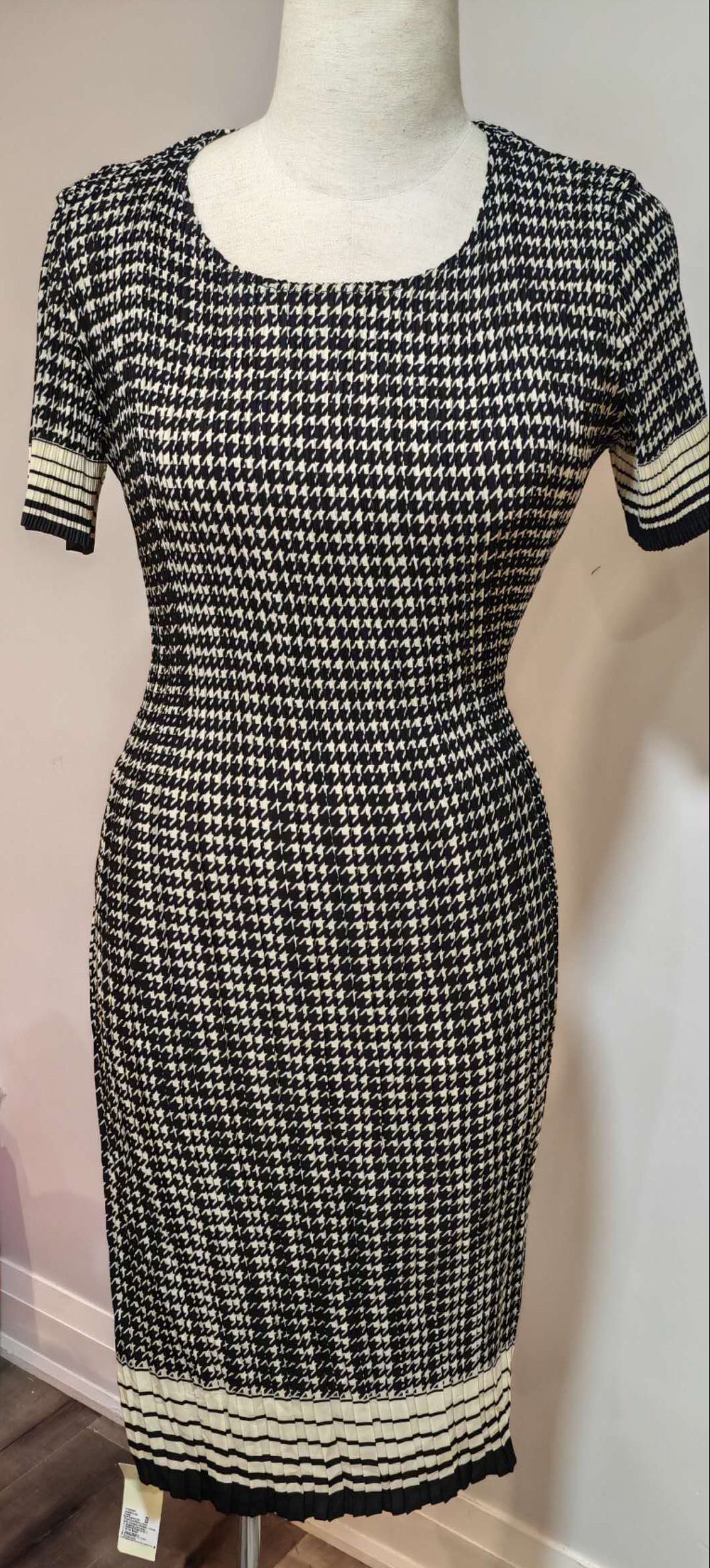 Black and white checkered dress on a mannequin with a blurred background