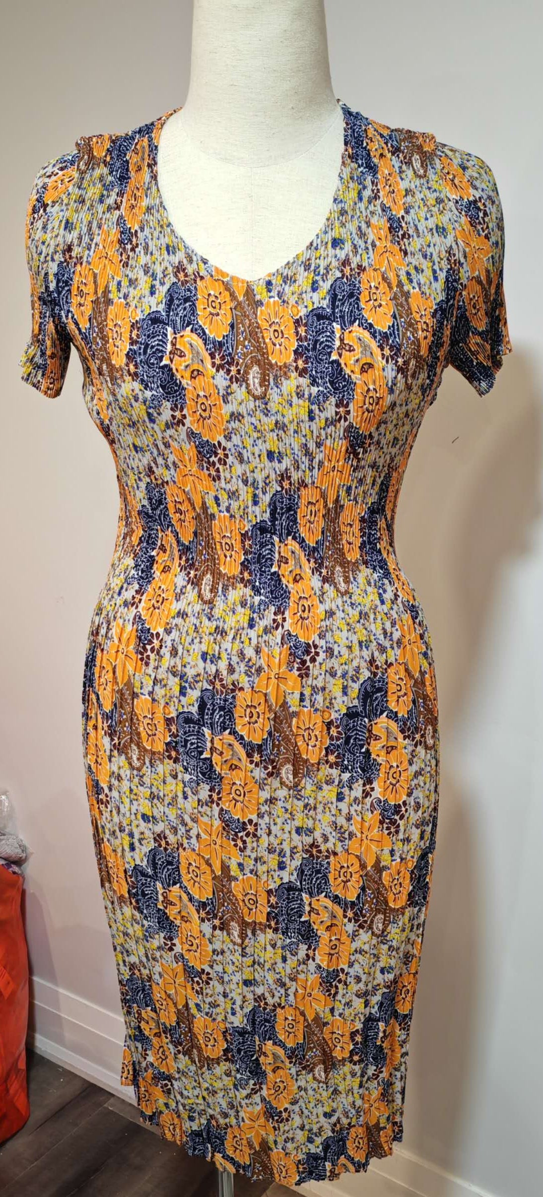 Floral dress on a mannequin against a plain background