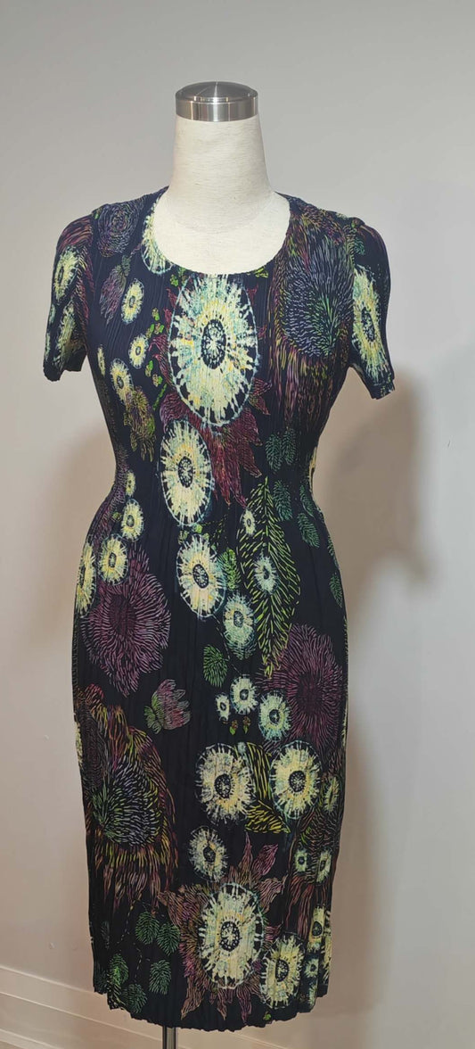 Mannequin wearing a floral patterned dress against a plain background