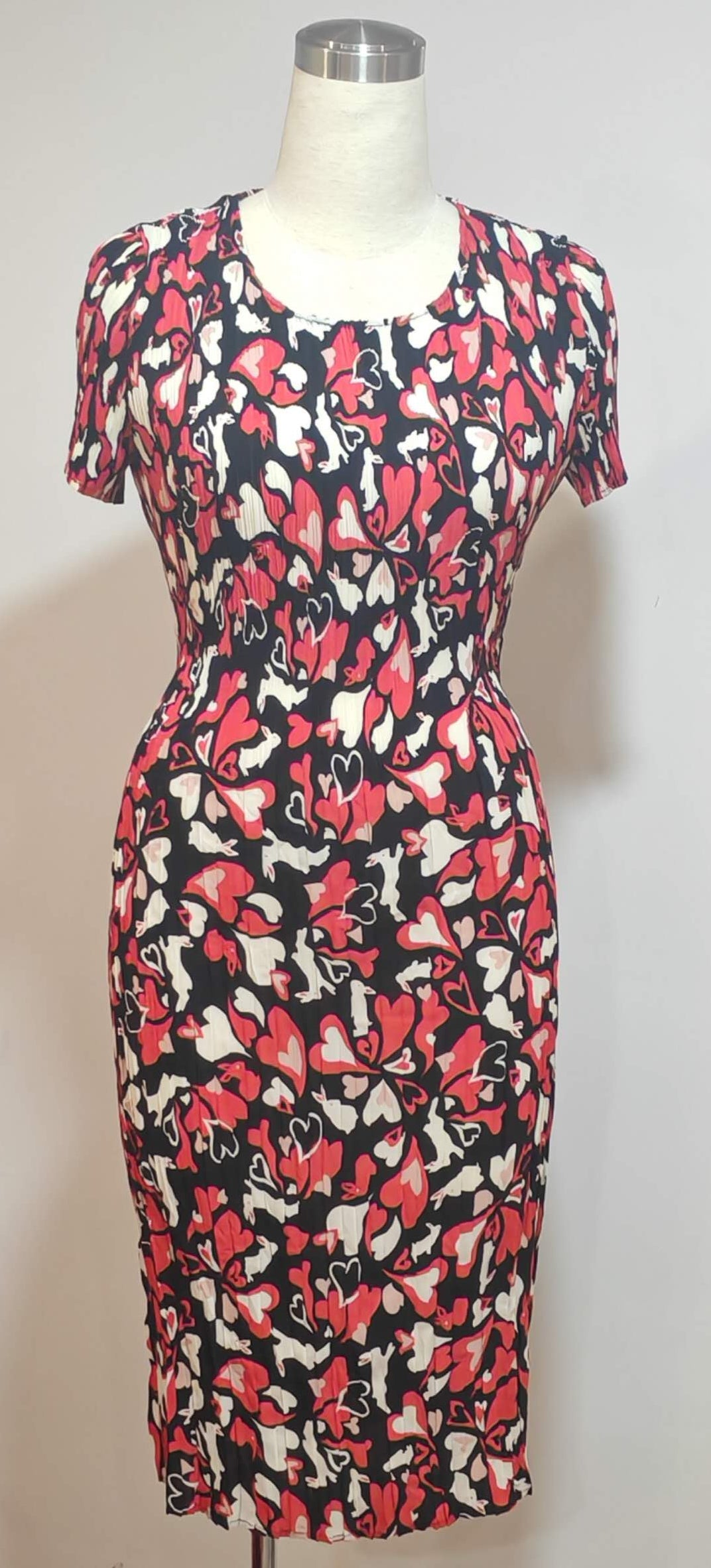 Dress with a colorful abstract pattern on a mannequin against a white background