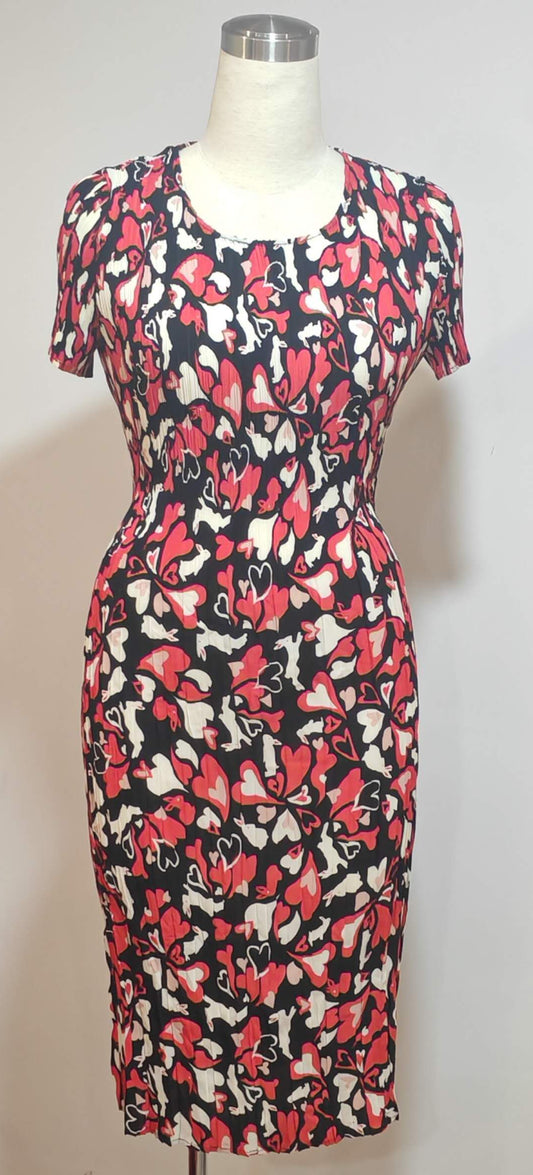 Dress with a colorful abstract pattern on a mannequin against a white background