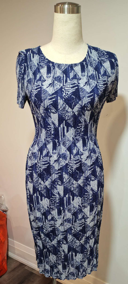 Blue patterned dress on a mannequin against a white wall.