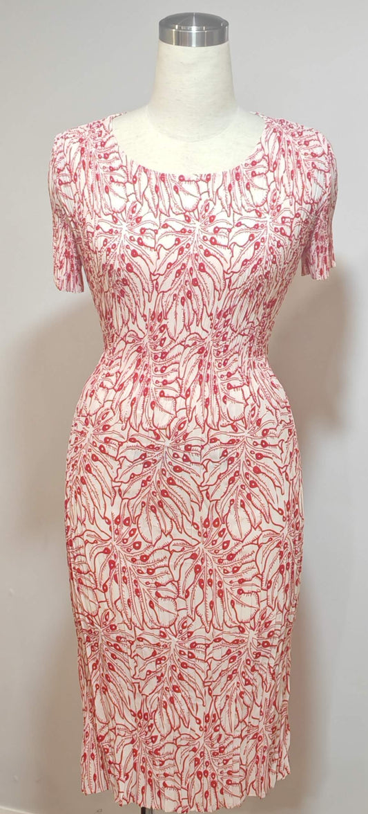 Red and white patterned dress on a mannequin against a white background