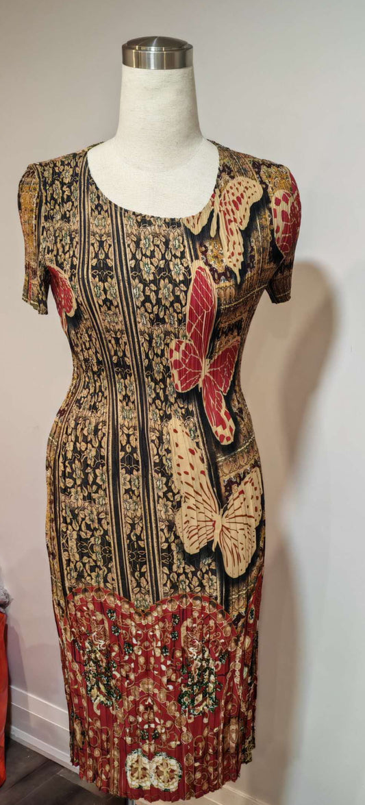 Patterned dress on a mannequin against a white wall