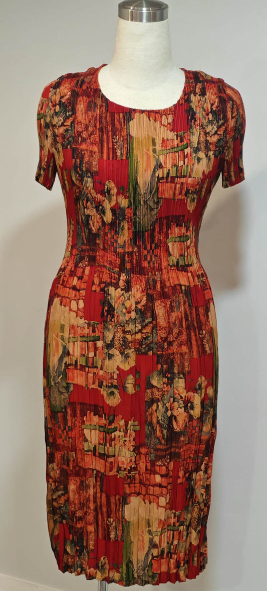 Colorful patterned dress on a mannequin against a white background