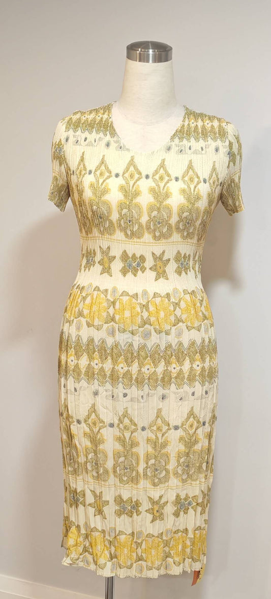 Mannequin wearing a patterned dress with yellow and white design on a plain background