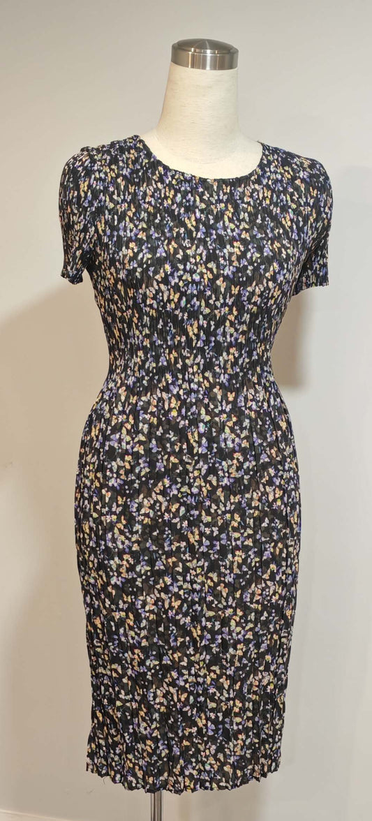 Floral dress on a mannequin against a white wall with a visible camera model 'HONOR 100 Pro'.