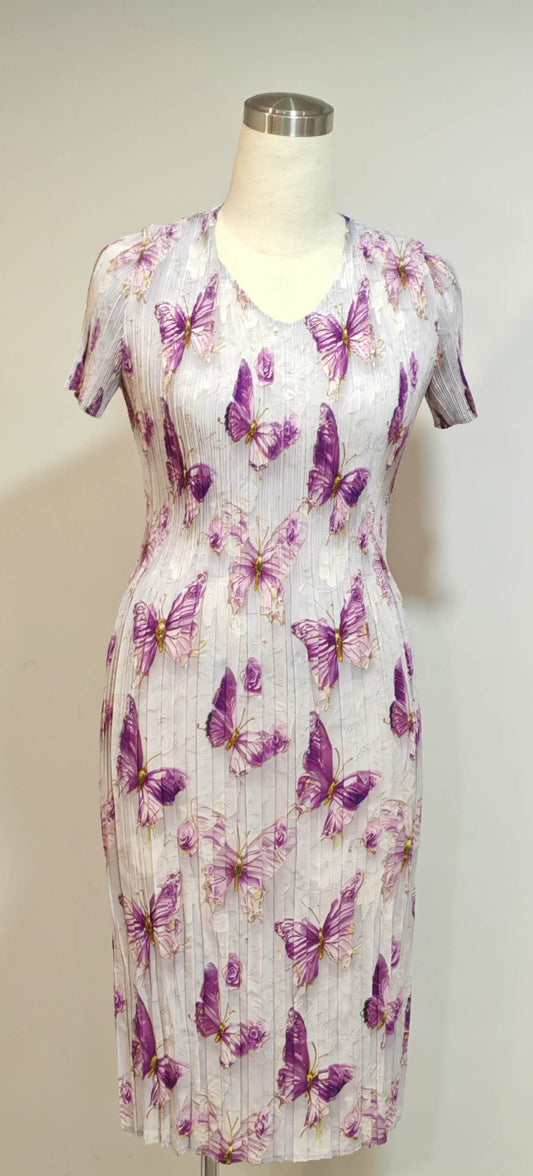 Dress with butterfly pattern on a mannequin against a white background